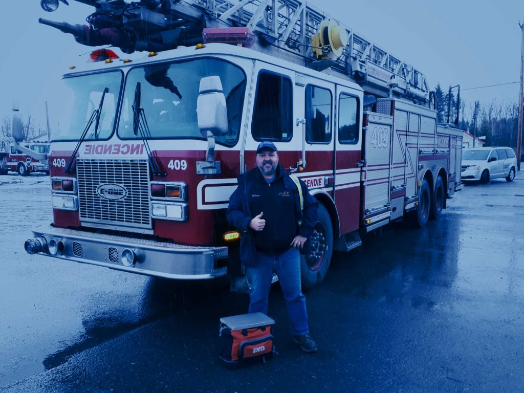 Image of a Transteck driver proud to have delivered a fire truck